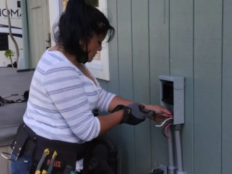 Licensed electrician wiring an exterior subpanel in Tupelo