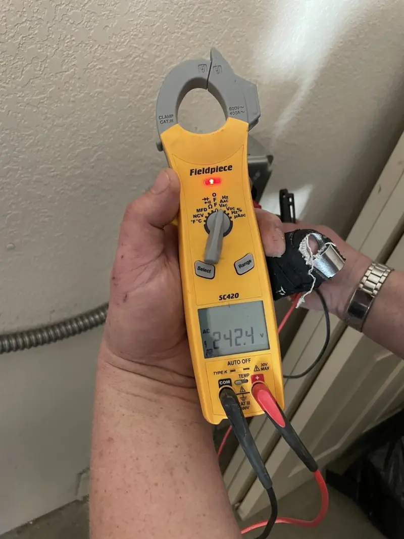Voltage testing with clamp meter during Ceiling Fan Installation in Tupelo